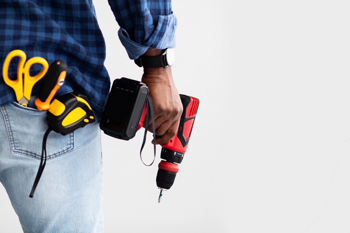 construction-worker-holding-drill-wearing-blue-pla-2026-03-24-02-21-25-utc.jpg