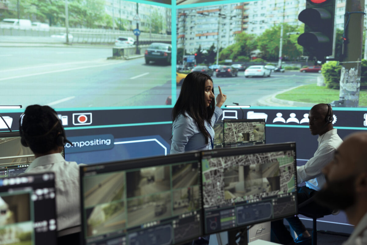 indian-woman-team-leader-guides-her-staff-monitor-surveillance-footage-scaled-e1777894954670.jpg