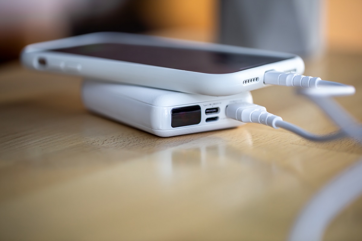 a-smartphone-is-charged-from-a-small-white-power-b-2026-03-24-05-27-29-utc