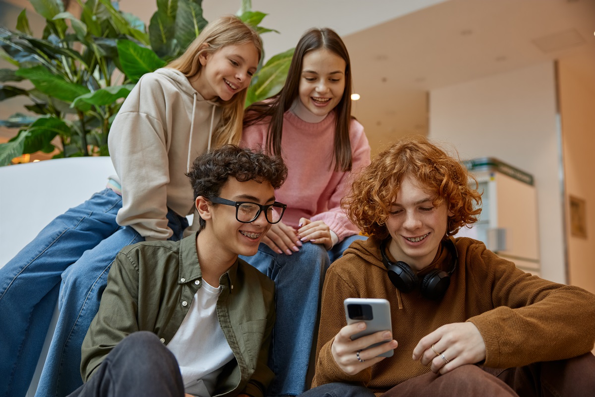 happy-teenage-friends-watching-funny-video-on-smar-2024-01-03-18-41-15-utc