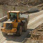 tractor-moving-down-narrow-road-surrounded-by-buil-2026-01-08-23-36-30-utc-scaled.jpg