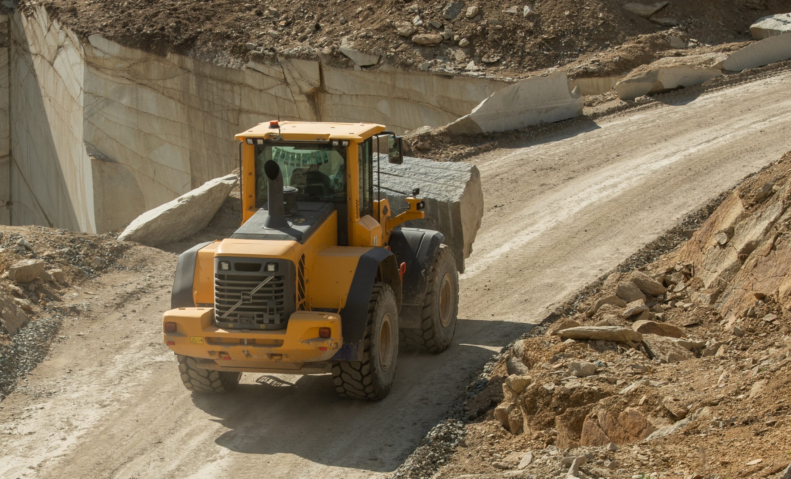 tractor-moving-down-narrow-road-surrounded-by-buil-2026-01-08-23-36-30-utc-scaled.jpg