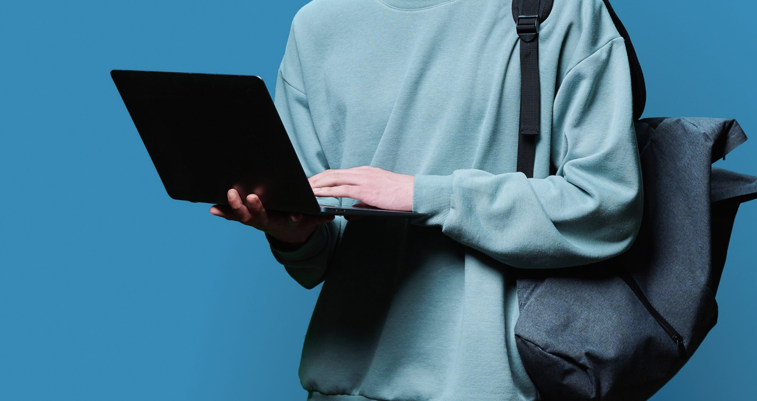 young-male-college-student-using-laptop-blue-stud-2024-12-08-03-14-37-utc-scaled.jpg